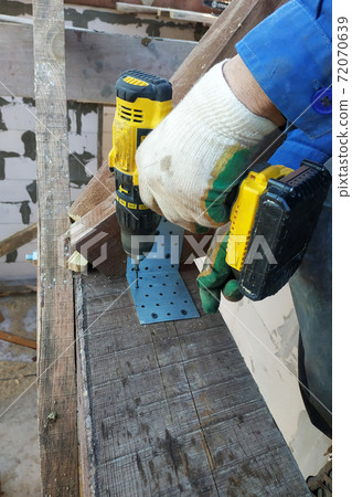 master screwdriver screwdriver screw into a wooden board 72070639