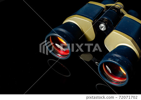 Military binoculars on black background close up 72071702