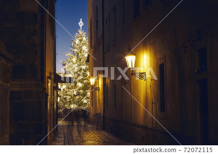 Narrow street Old Town against illuminated Christmas tree 72072115