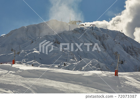 Mountain skiing slopes, snowy Alpine landscape 72073387