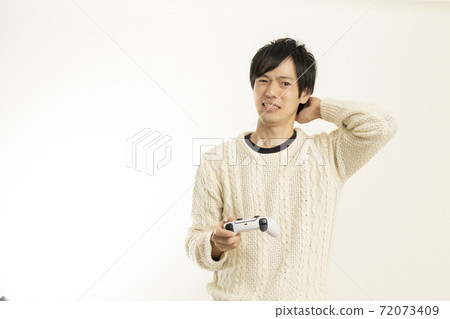Men enjoying video games on the latest game consoles / game controllers / PS5 / Sony PlayStation Men enjoying video games on the latest game consoles / game controllers / PS5 / Sony PlayStation 72073409