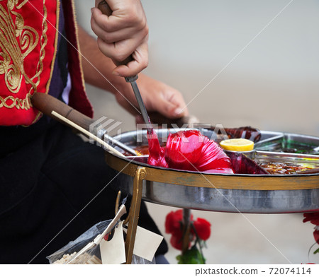 Macun, sweet Turkish toffee paste cooking on street in Turkey Macun, sweet Turkish toffee paste cooking on street in Turkey 72074114