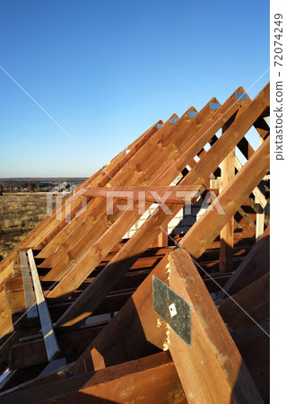exposing the rafters to the background of the blue sky 72074249