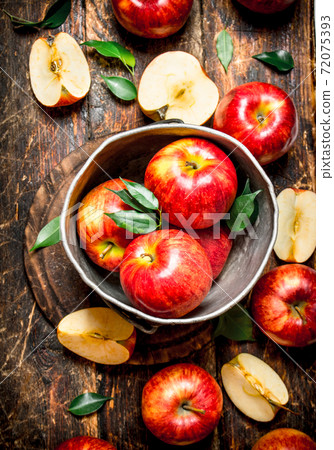 Red apples in an old bucket. Red apples in an old bucket. 72075393