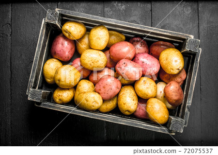 Fresh potatoes in an old box. Fresh potatoes in an old box. 72075537