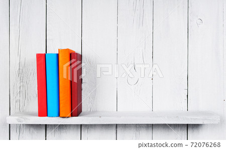 Books on a wooden shelf. Books on a wooden shelf. 72076268