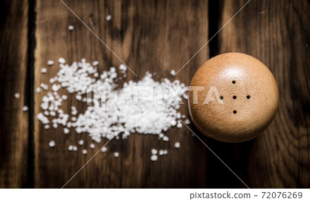 Salt with coarse salt. On wooden background. Salt with coarse salt. On wooden background. 72076269