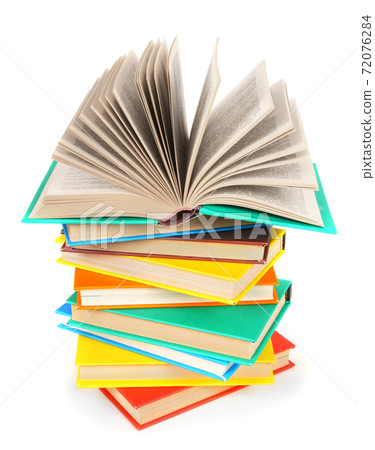 The open book on a pile of multi-coloured books. The open book on a pile of multi-coloured books. 72076284