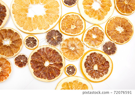 mix of different pieces of dried citrus fruit on white background 72076591