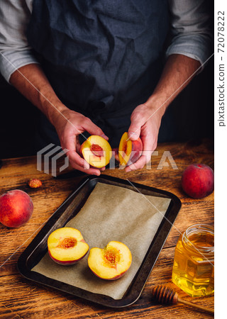 Preparing of fresh and ripe peaches with honey Preparing of fresh and ripe peaches with honey 72078222