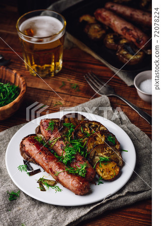Baked Pork Sausages with Slices of Eggplant 72078224