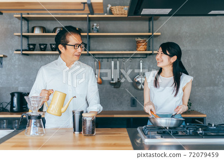 Men and women cooking in the kitchen 72079459