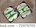 Delicious bagel sandwich lunch box on wooden cutting board. Salmon bagel sandwich and potato bagel sandwich. Cooking 72079705