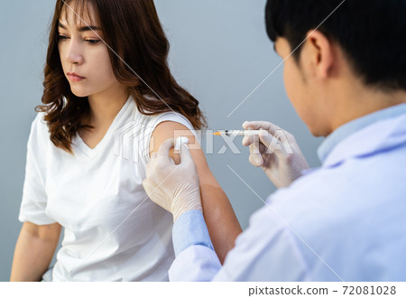 doctor holding syringe and using cotton before make injection to patient. Covid-19 or coronavirus vaccine doctor holding syringe and using cotton before make injection to patient. Covid-19 or coronavirus vaccine 72081028