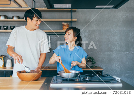 A couple cooking in the kitchen A couple cooking in the kitchen 72081058