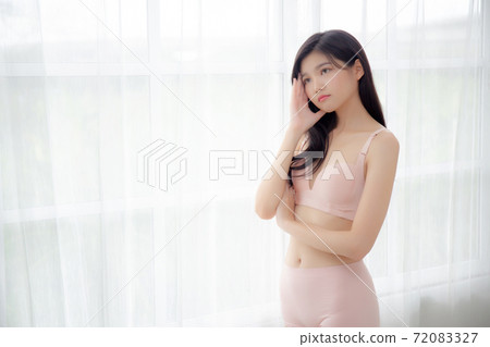 Beautiful portrait young asian woman sexy thinking idea weight loss near the windows for healthy. 72083327