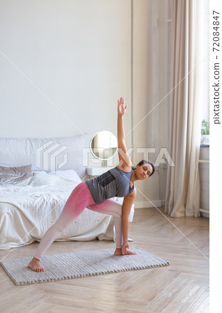 African American woman doing pilates exercise at home. African American woman doing pilates exercise at home. 72084847