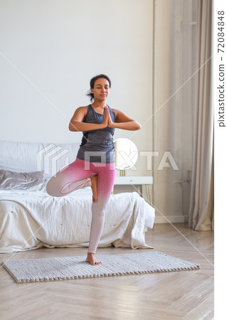 African American woman doing yoga at home. African American woman doing yoga at home. 72084848