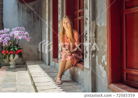 Woman tourist on background of Temple Ngoc Son in Hanoi, Vietnam.Temple of Literature is also called temple of Confucius. Vietnam reopens after coronavirus quarantine COVID 19 72085359