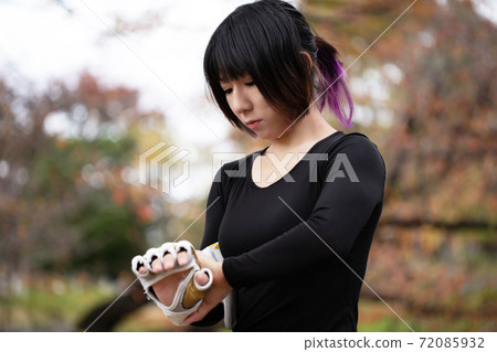 Woman wearing gloves in the park 72085932