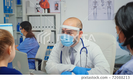 Child and male doctor talking and laughing Child and male doctor talking and laughing 72088213
