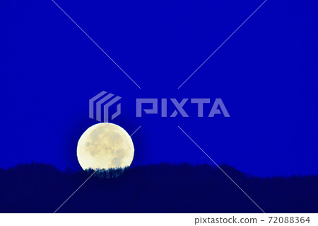 Hakushu-cho, Hokuto City. Blue hour before dawn, full moon in November over the forest on the edge of the mountain Hakushu-cho, Hokuto City. Blue hour before dawn, full moon in November over the forest on the edge of the mountain 72088364
