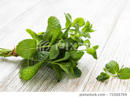 Fresh mint leaves on old wooden  background, flat lay 72088769