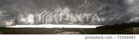 On the horizon there are stormy clouds over the meadow 72088985
