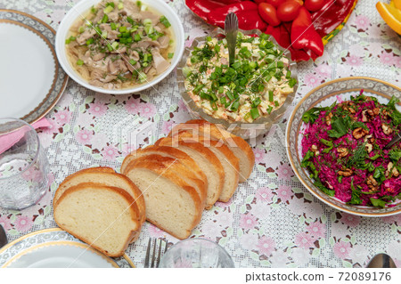 Salads and side dishes in plates on the table Salads and side dishes in plates on the table 72089176