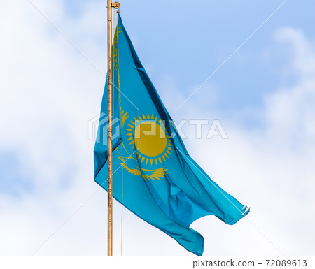 Flag of the Republic of Kazakhstan against the sky with clouds Flag of the Republic of Kazakhstan against the sky with clouds 72089613