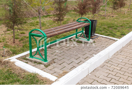 Wooden bench stands in the park 72089645