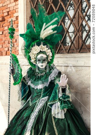 venetian party dress Carnival in Venice - woman in venetian green... - Stock Photo [72089848]