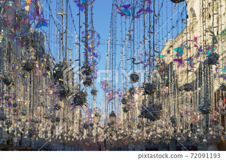 Famous pedestrian touristic Nikolskaya street during coronavirus pandemic time. View at the sky, festive decoration and facades of houses. Famous pedestrian touristic Nikolskaya street during coronavirus pandemic time. View at the sky, festive decoration and facades of houses. 72091193