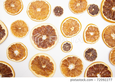 mix of different pieces of dried citrus fruit on white background 72092277