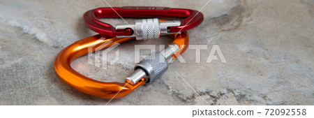 Screw gate carabiners on a marble top 72092558