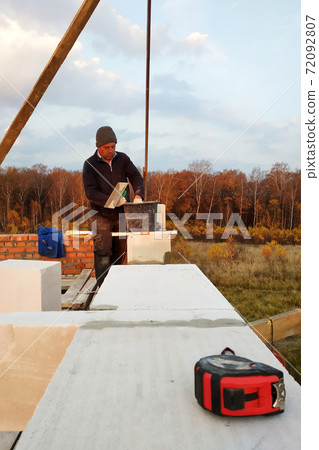 The masonry mooring the wall in the fresh air with a trowel and glue solution The masonry mooring the wall in the fresh air with a trowel and glue solution 72092807