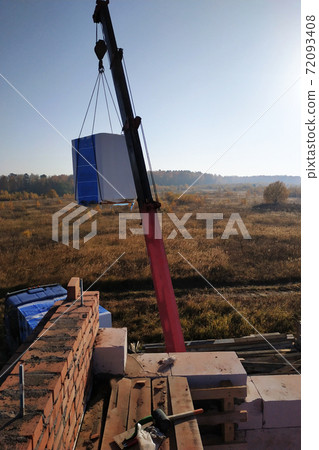 The truck crane transports blocks to the construction site blocks in the air against the sky The truck crane transports blocks to the construction site blocks in the air against the sky 72093408