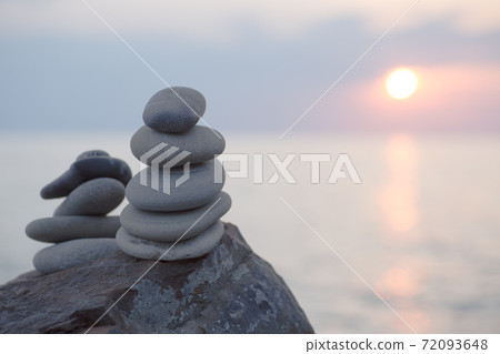 Stones pyramid on sand symbolizing zen, harmony, 72093648