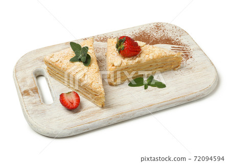 Board with pieces of Napoleon cake isolated on white background Board with pieces of Napoleon cake isolated on white background 72094594