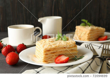 Concept of tasty lunch with Napoleon cake on gray wooden background Concept of tasty lunch with Napoleon cake on gray wooden background 72094699