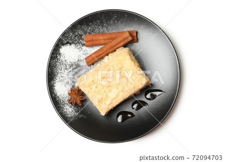 Plate with piece of Napoleon cake with cinnamon isolated on white background Plate with piece of Napoleon cake with cinnamon isolated on white background 72094703