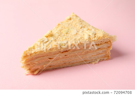Piece of delicious Napoleon cake on pink background 72094708