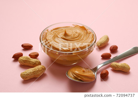 Peanut, bowl and spoon with peanut butter on pink background Peanut, bowl and spoon with peanut butter on pink background 72094737