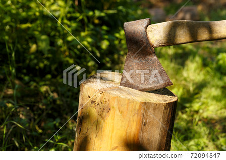Ax stuck in the stump. 72094847