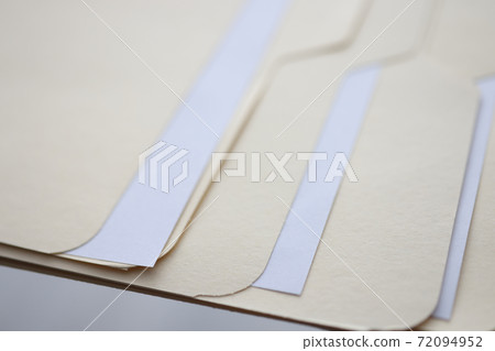 Beige folders with documents are on table Beige folders with documents are on table 72094952