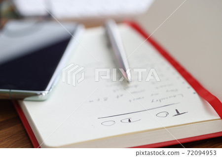 On the table is diary with to-do list. On the table is diary with to-do list. 72094953