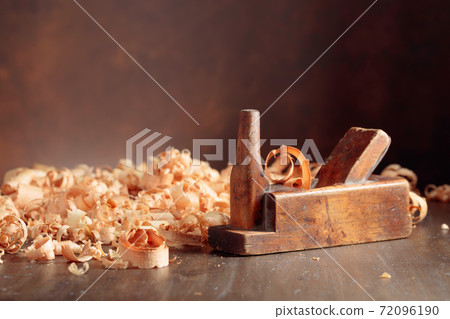 Old wooden jointer and shaving on wooden table. Old wooden jointer and shaving on wooden table. 72096190