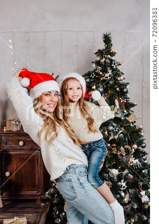 Funny Portrait of happy family in santa claus hat with Christmas gifts at home. Happy New Year 72096381