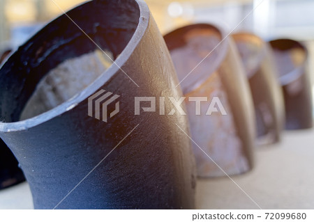 Black metal pipes and adapters of different diameters for gasification or water supply. Industrial background  72099680