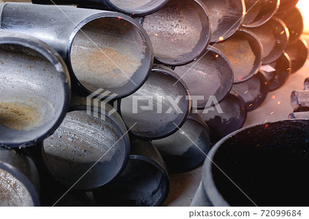 Black metal pipes and adapters of different diameters for gasification or water supply. Industrial background Black metal pipes and adapters of different diameters for gasification or water supply. Industrial background 72099684